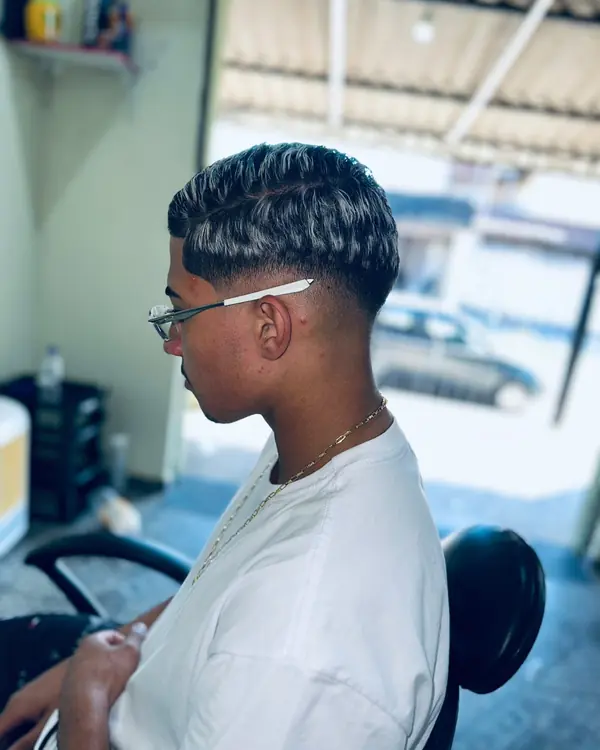 Corte texturizado com reflexo e degradê, cliente de óculos